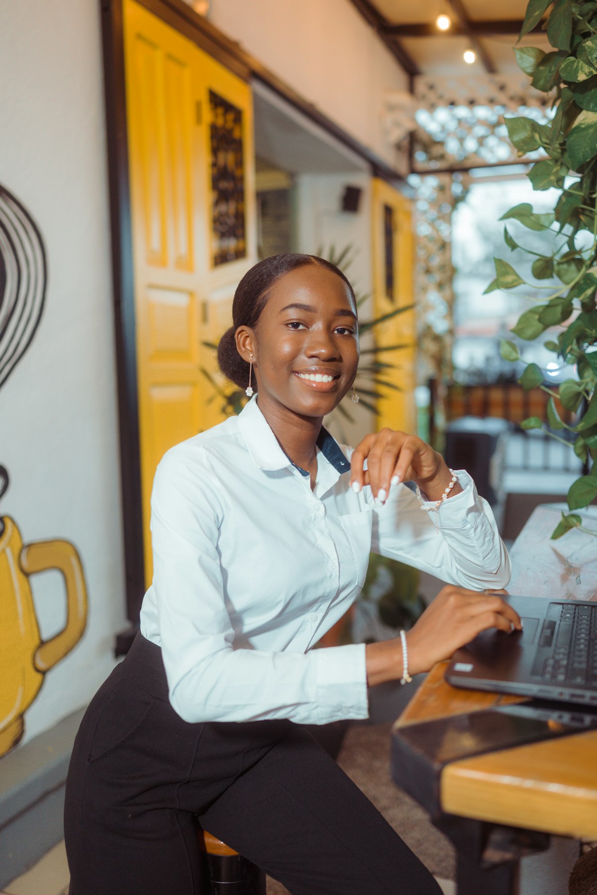 A support professional smiling while working on a laptop